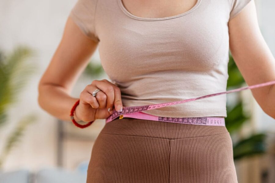 woman measuring her waist after starting compounded semaglutide in Ashburn, VA