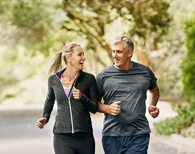 older man and woman running together after getting hormone therapy in Ashburn, VA
